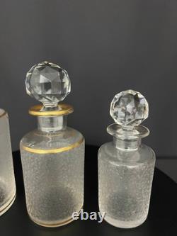 Suite de trois flacons de toilette en cristal givré et doré, Saint-Louis